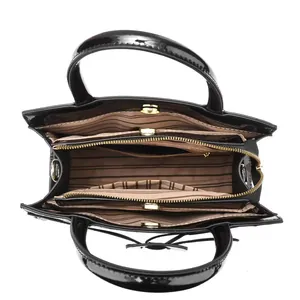 Top view of patent leather handbag with triple compartments and striped lining