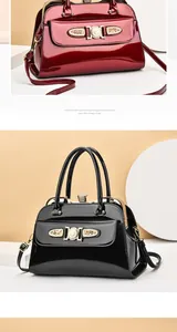Close-up of glossy patent leather handbags with vintage frame and metal buckle detail