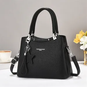 Fashionable black pebble leather tote bag with star charm and adjustable strap for women