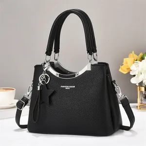 Large black lychee pattern tote bag with star pendant and removable crossbody strap
