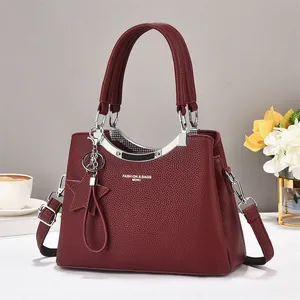 Burgundy litchi texture handbag with double handles and silver metallic arch detail