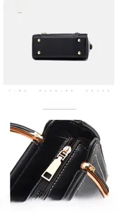Detail of lychee pattern leather bag with golden zipper and protective metal feet