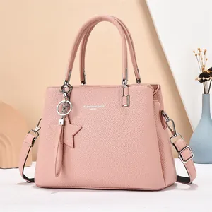Pink lychee texture leather handbag with adjustable shoulder strap and star charm
