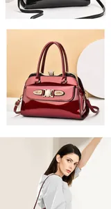 Detail of glossy patent leather handbag with gold metal hardware and diamond-encrusted frame