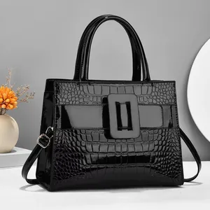Glossy black croc-embossed tote bag with large square buckle and top handles