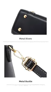 Detail of gold-plated studs and lobster clasp on black pebbled leather handbag
