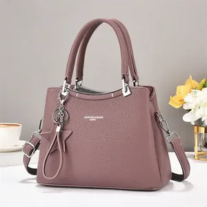 Elegant purple pebbled leather tote bag with silver star charm and dual handles