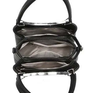Top view of large black tote bag featuring three compartments and grey herringbone lining