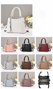Close-up of litchi texture PU leather tote showing detailed stitching and star charm