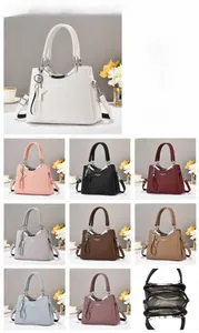 Detail view of large capacity PU leather handbag with triple compartment inner structure