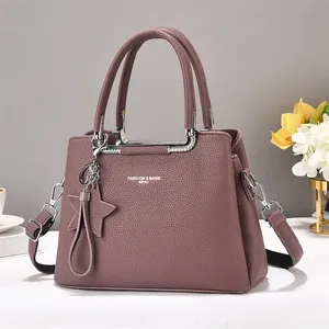 Light purple pebbled leather tote bag with silver hardware and star charm details