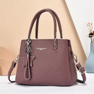 Elegant purple lychee leather handbag with adjustable strap and star tassel accessory