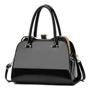 Elegant black patent leather handbag with rhinestone trim and golden hardware