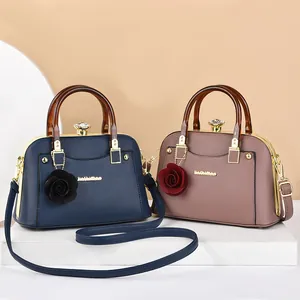 Elegant leather shell handbags with amber handles and crystal clasp in blue and pink