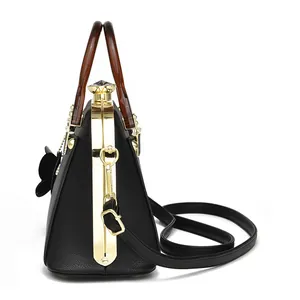 Black litchi pattern shell handbag with amber resin handle and golden metal frame