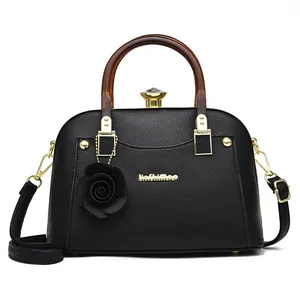 Elegant black lychee leather shell handbag with wooden handle and rose pendant decoration