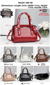 Detail showing various colors of embossed leather handbags with floral silk handle scarf