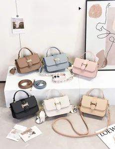 Close-up of textured flap bags in six colors with dual strap options and gold buckles