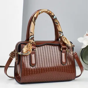 Fashionable dark brown embossed leather handbag for women with a decorative silk scarf