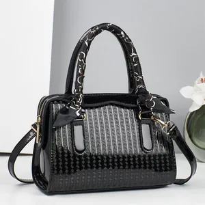 Elegant black embossed faux leather handbag with silk scarf handle and gold hardware