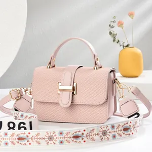 Detailed texture of pink fabric pattern leather bag with ethnic style wide strap