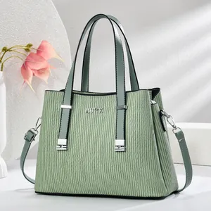 Sage green pleated handbag with MUWK logo, dual handles and adjustable shoulder strap