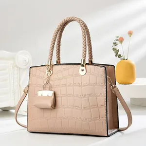 Elegant beige tote bag with crocodile pattern and decorative mini pouch pendant