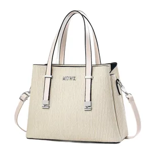 Chic beige handbag with pleated vertical stripes and silver MUWK logo in a front view