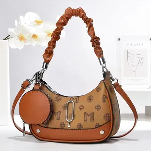 Brown monogram crescent underarm bag with pleated handle and mini round coin purse charm