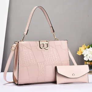 Pink crocodile-embossed tote bag with small envelope pouch and gold B hardware