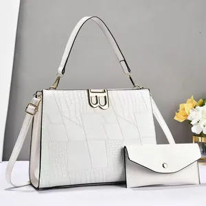 White faux-crocodile tote bag and envelope clutch set with golden B-logo hardware