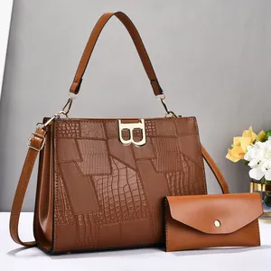 Detail of caramel brown patchwork bag set with embossed leather and gold 'B' buckle