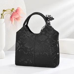Detailansicht der schwarzen Handtasche mit Schlangenhautmuster und dekorativem Seidenschal
