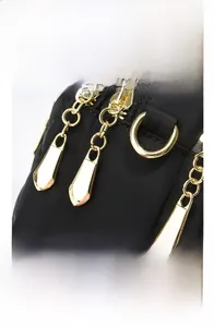 Detail of textured Oxford fabric and golden multi-layer electroplated zipper pullers