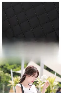 Detail of black quilted crossbody phone bag with fine stitching and slim shoulder strap