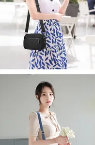 Detail of black quilted crossbody bag with adjustable strap and silver metal zipper