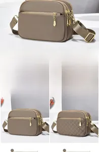 Detail view of khaki waterproof nylon crossbody bags in plain and quilted textures