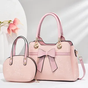 Set di borse rosa motivo a serpente con fiocco a farfalla e mini pochette abbinata