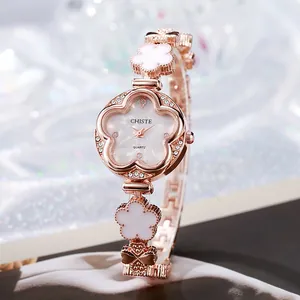 Montre fleur or rose pour femme avec strass brillants et cadran en nacre élégant