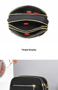 Detailed view of black quilted crossbody bag with three zipper pockets and gold hardware