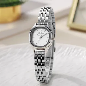 Elegant silver stainless steel ladies watch with tonneau case on a white tray