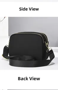 Detail of black nylon crossbody bag featuring double zippers and golden metal hardware