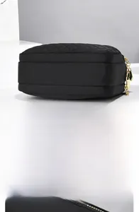 Detailed view of the quilted nylon phone bag with premium golden zippers and bottom stitching