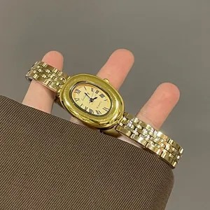 Vintage gold oval quartz watch with champagne roman dial and link strap for women