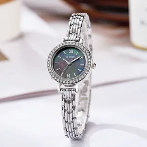 Detailed macro view of the silver watch with rhinestone bezel and dark gray mother of pearl dial