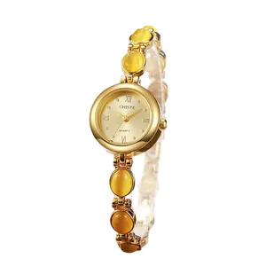 Elegante reloj de pulsera de cuarzo dorado para mujer con piedras ojo de gato amarillas