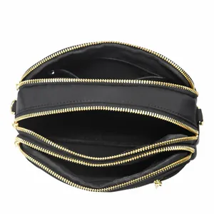 Three-layer black nylon quilted crossbody bag with gold zippers and ample storage space