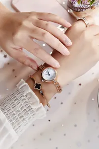 Elegant rose gold watch set with clover bracelet and sparkling ring on soft tulle