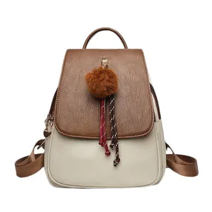 Two-tone retro leather backpack in cream and brown with plush charm and woven detail