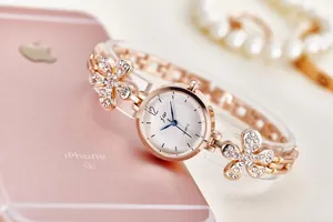 Close-up of rose gold fashion quartz watch with sparkling rhinestone floral bracelet band